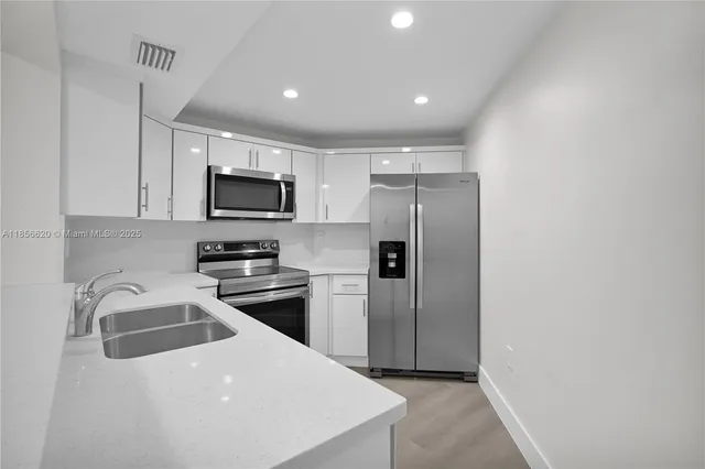 a kitchen with a refrigerator sink and microwave