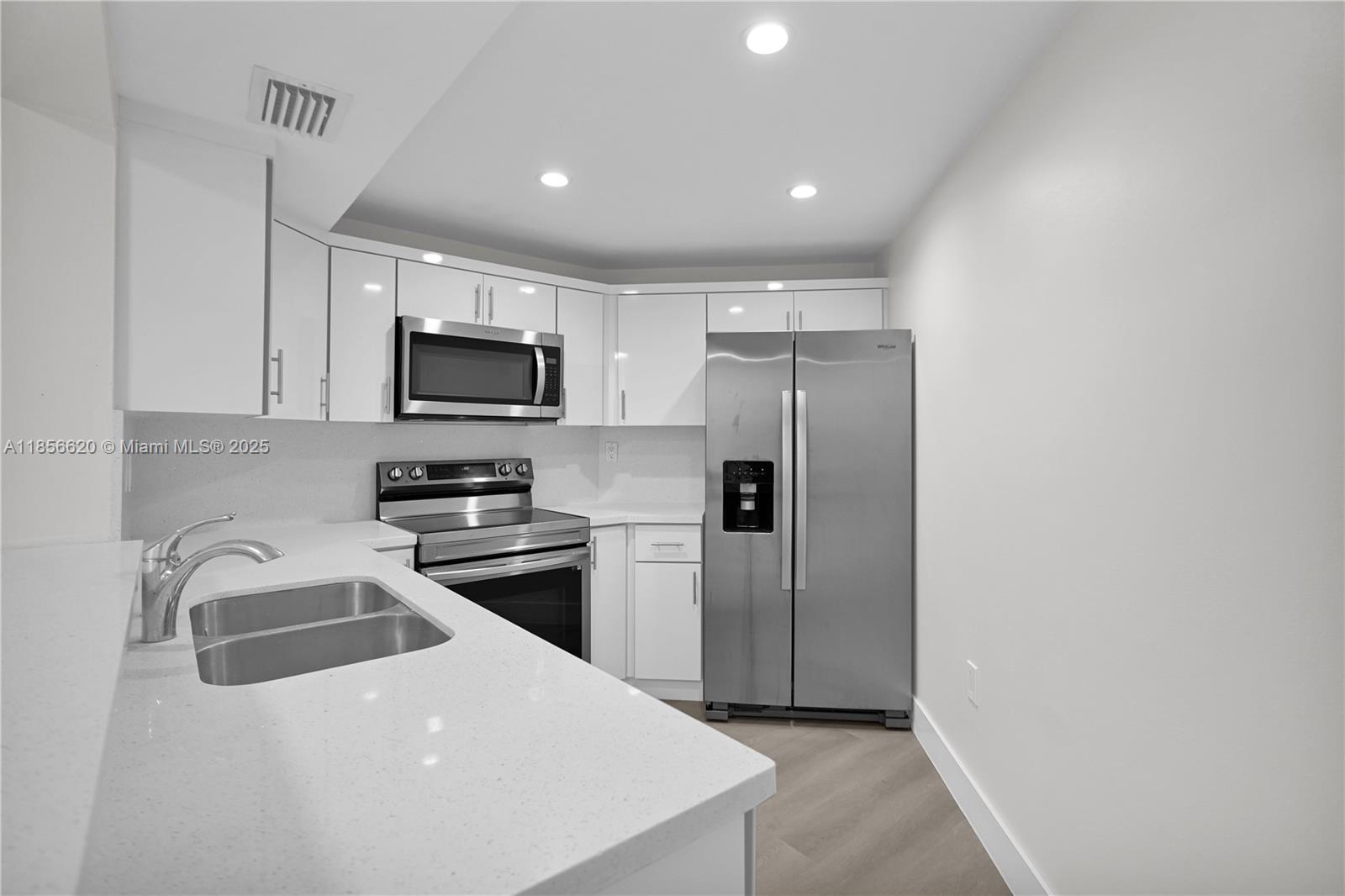 a kitchen with a refrigerator sink and microwave
