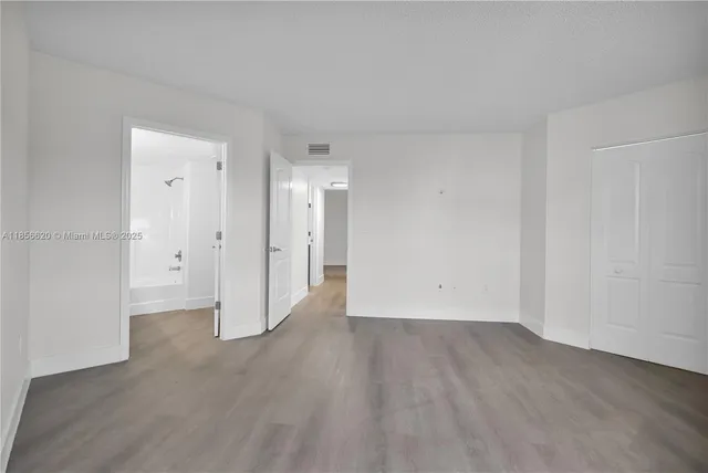 an empty room with wooden floor