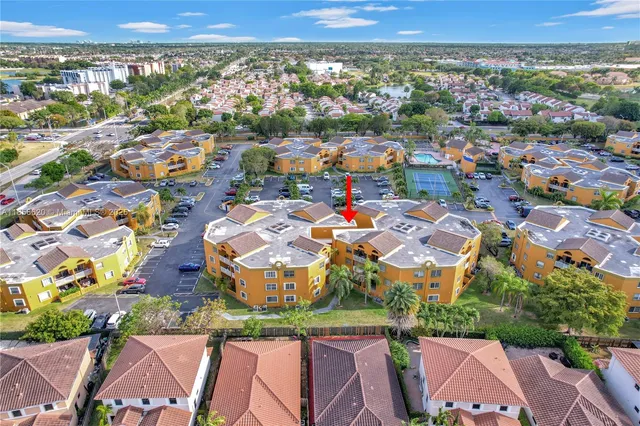a sign board with buildings in the background