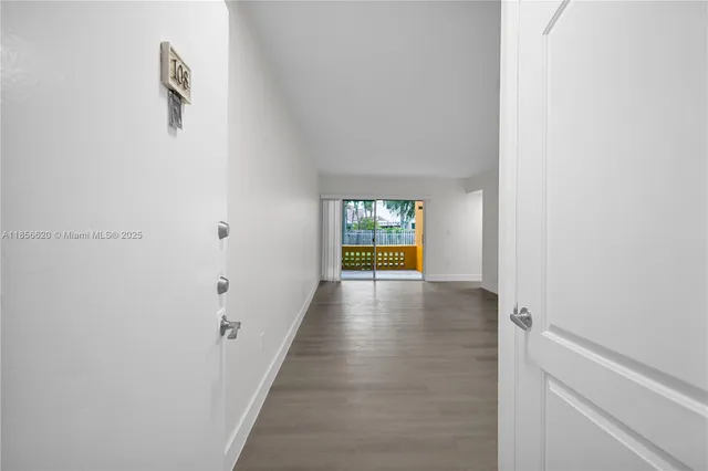 a view of hallway with wooden floor