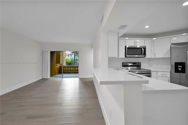 a kitchen with microwave a stove and refrigerator