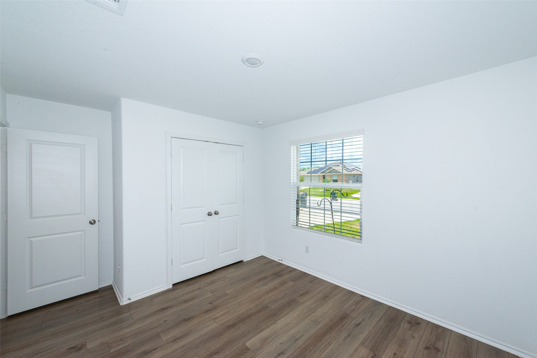 147 Otter Road Kyle, TX 78640 - Photo 5 of 34 Bedroom #2 entry on left, closet door on right