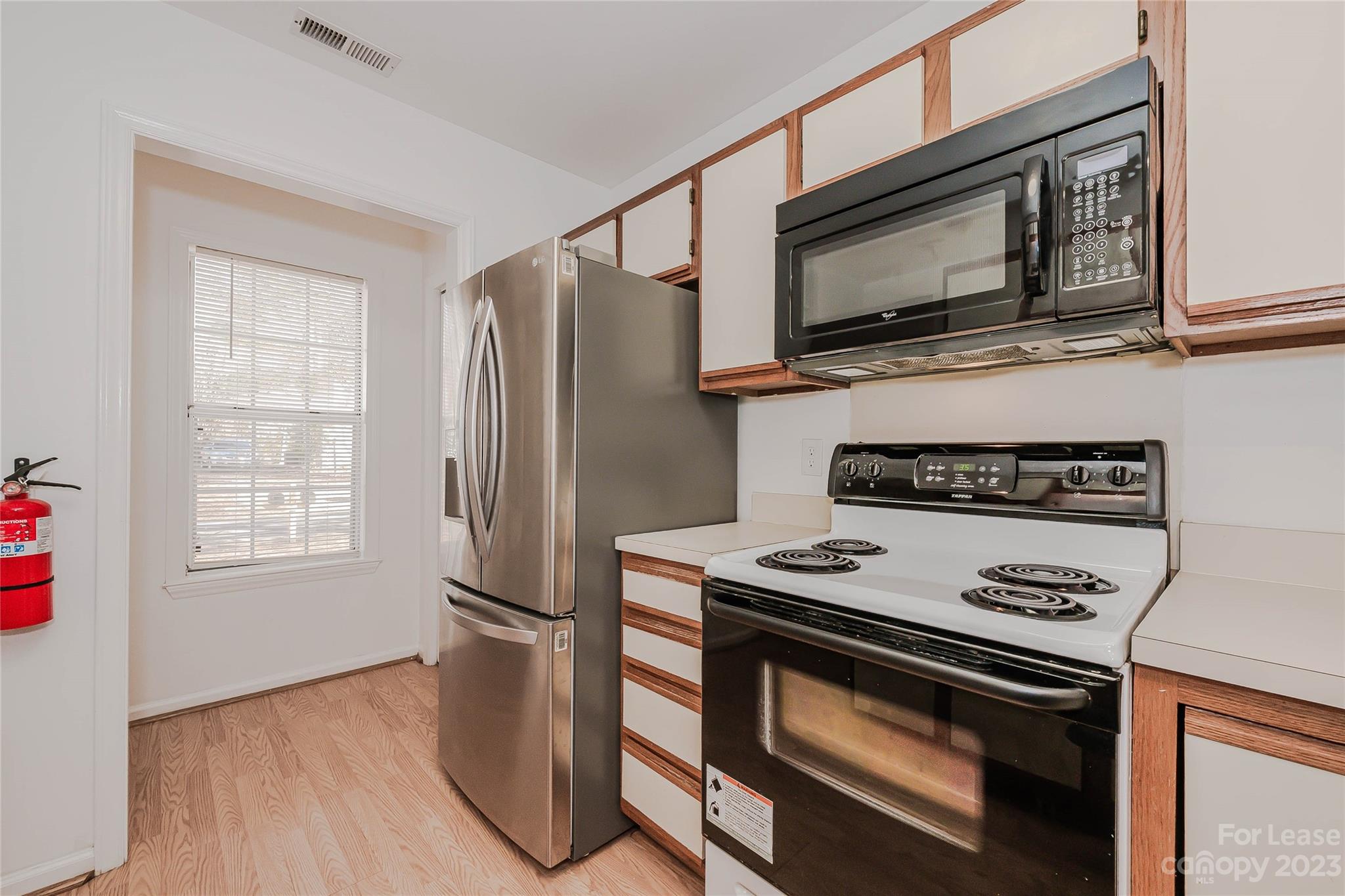 6619 Bevington Ridge Road, Unit A Charlotte, NC 28277 - Photo 13 of 27 a kitchen with a stove microwave and refrigerator