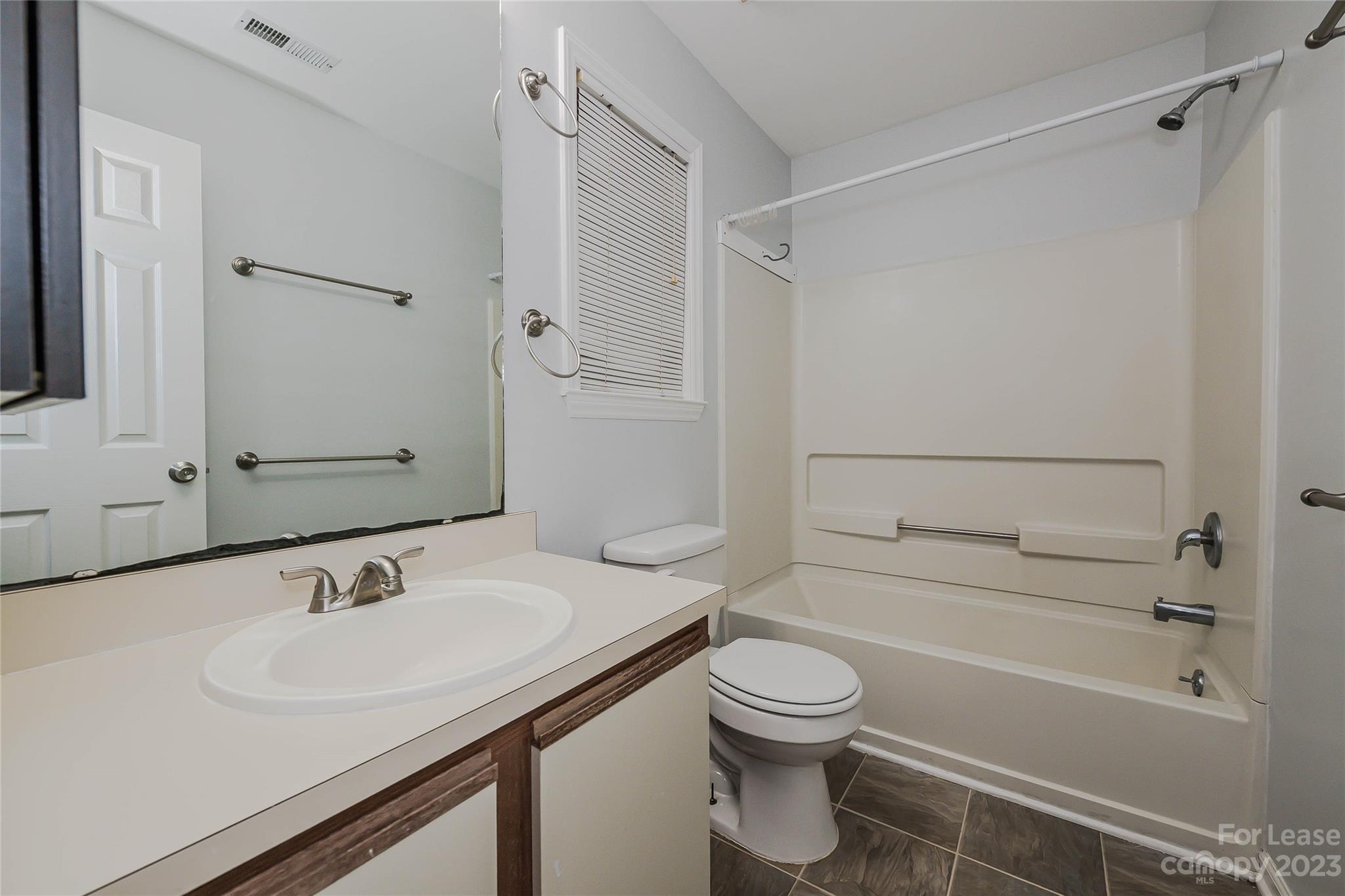 6619 Bevington Ridge Road, Unit A Charlotte, NC 28277 - Photo 18 of 27 a bathroom with a sink a toilet and shower