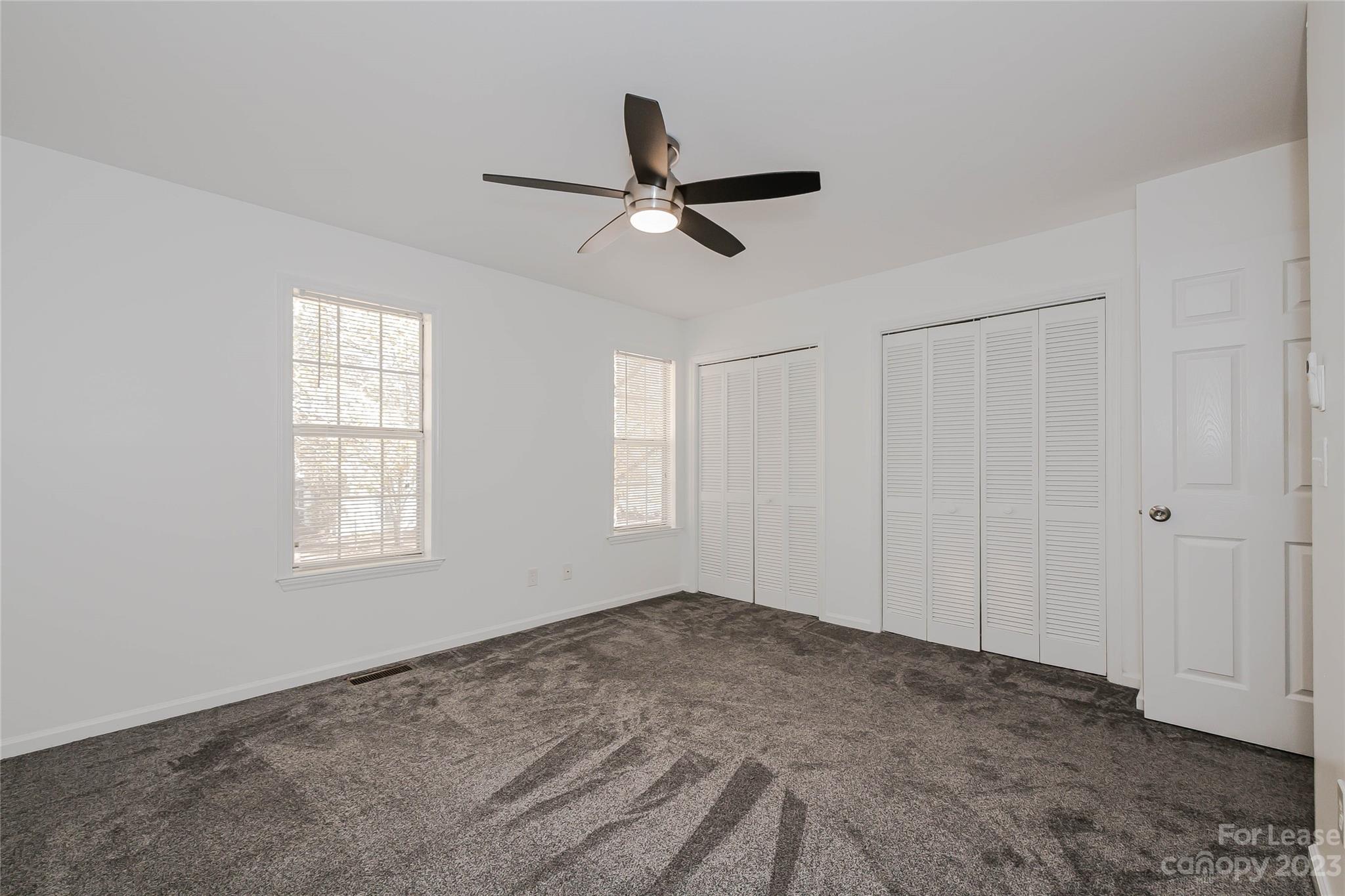 6619 Bevington Ridge Road, Unit A Charlotte, NC 28277 - Photo 20 of 27 a view of empty room with window and ceiling fan
