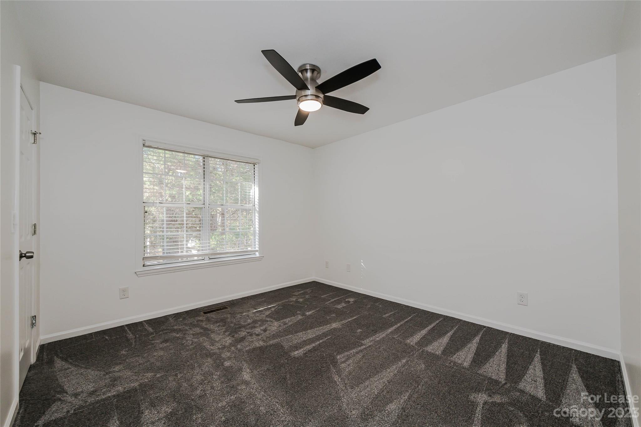 6619 Bevington Ridge Road, Unit A Charlotte, NC 28277 - Photo 23 of 27 a view of a livingroom with a ceiling fan and window