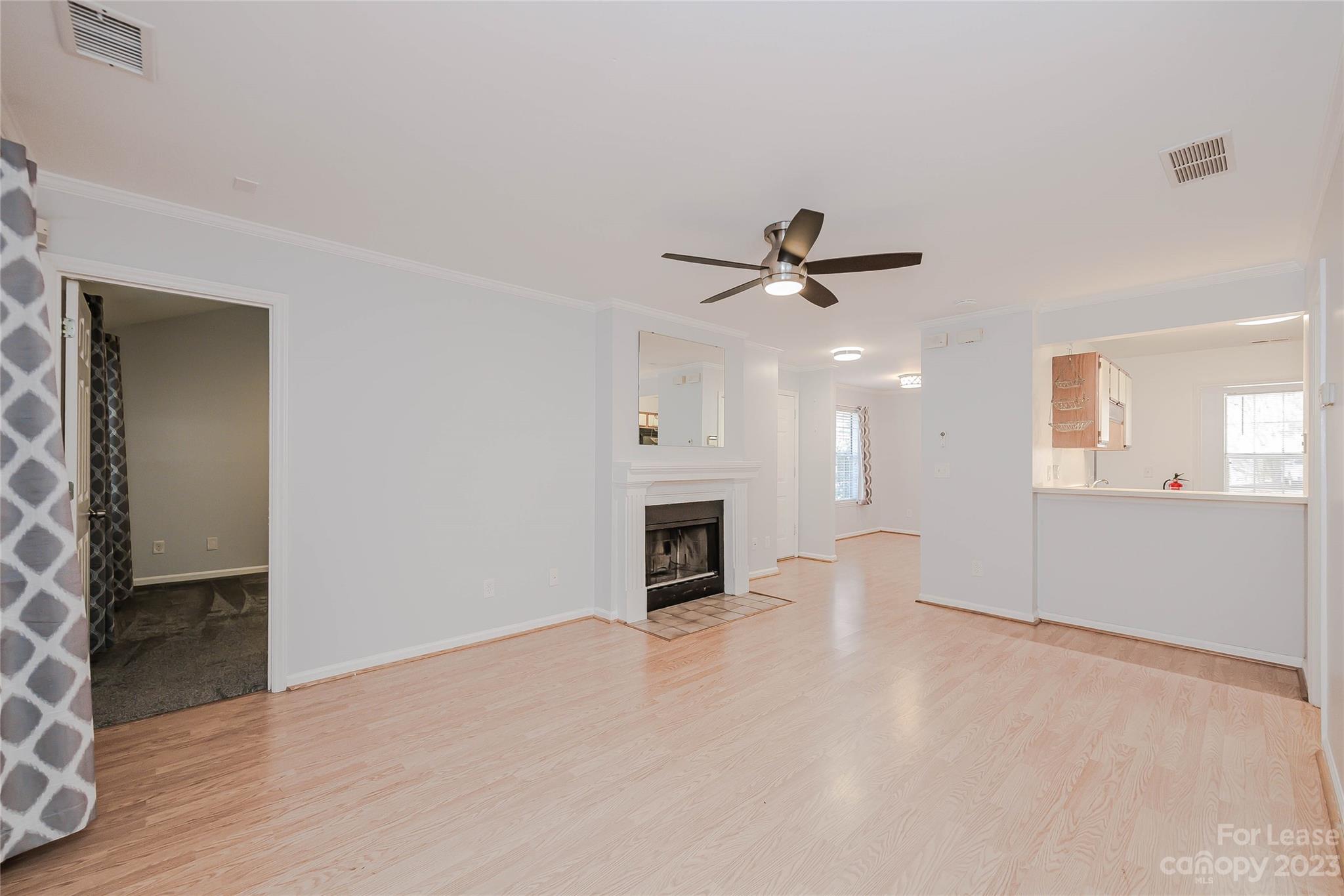 6619 Bevington Ridge Road, Unit A Charlotte, NC 28277 - Photo 6 of 27 an empty room with fireplace and a ceiling fan