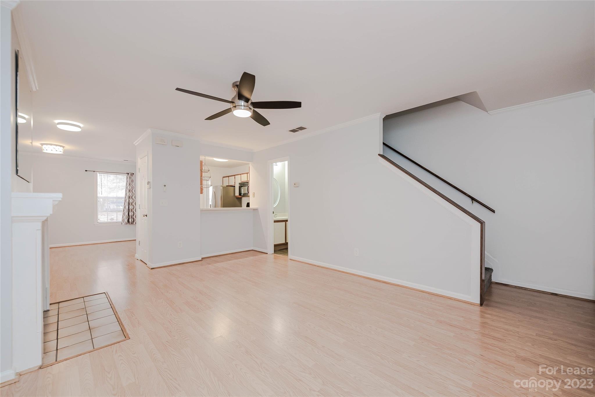 6619 Bevington Ridge Road, Unit A Charlotte, NC 28277 - Photo 7 of 27 a view of an empty room with wooden floor and a ceiling fan
