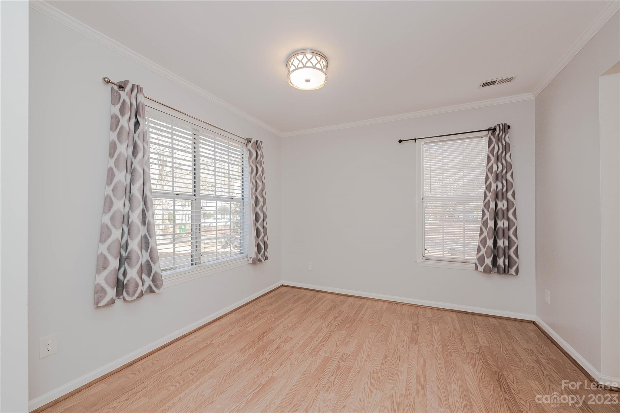 6619 Bevington Ridge Road, Unit A Charlotte, NC 28277 - Photo 9 of 27 an empty room with wooden floor and windows