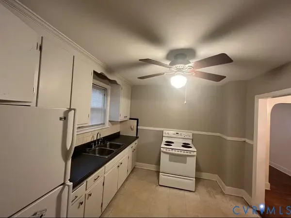 a kitchen with a refrigerator and a sink