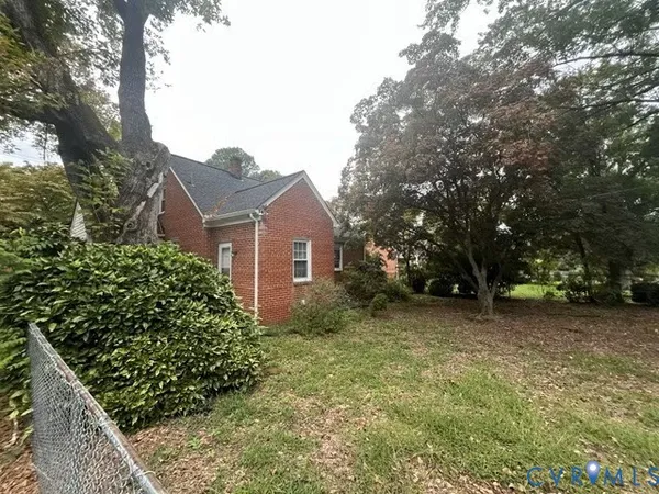 a view of a house with a tree in front of it