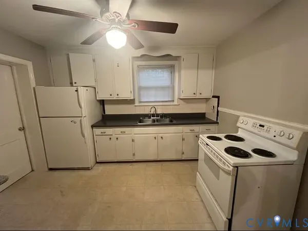 a kitchen that has a cabinets and a stove top oven