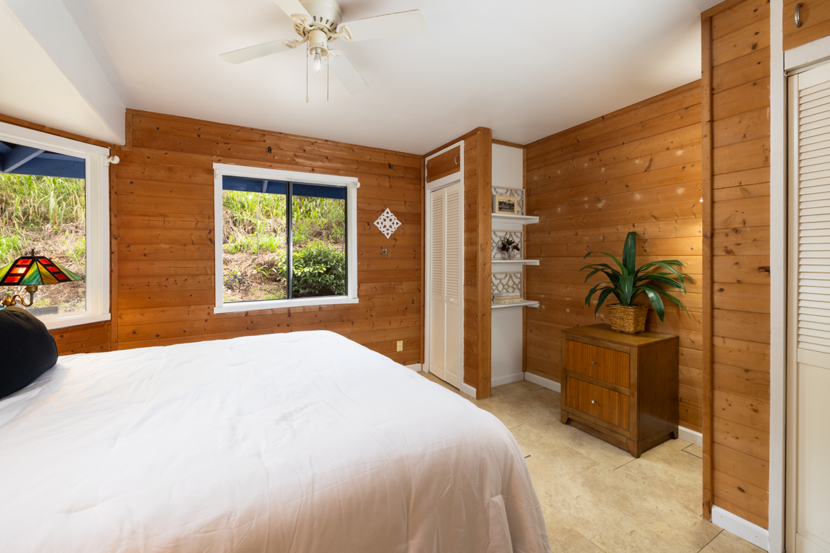45-1006 Kalehua Road Honokaa, HI 96727 - Photo 11 of 29 a bedroom with a bed and a chandelier