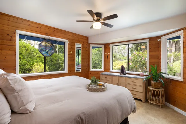 a bedroom with a large bed and a large window