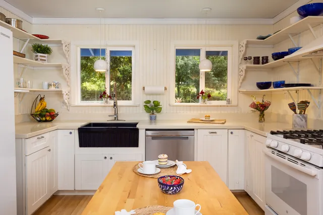 a kitchen with stainless steel appliances kitchen island granite countertop a stove a sink and a microwave