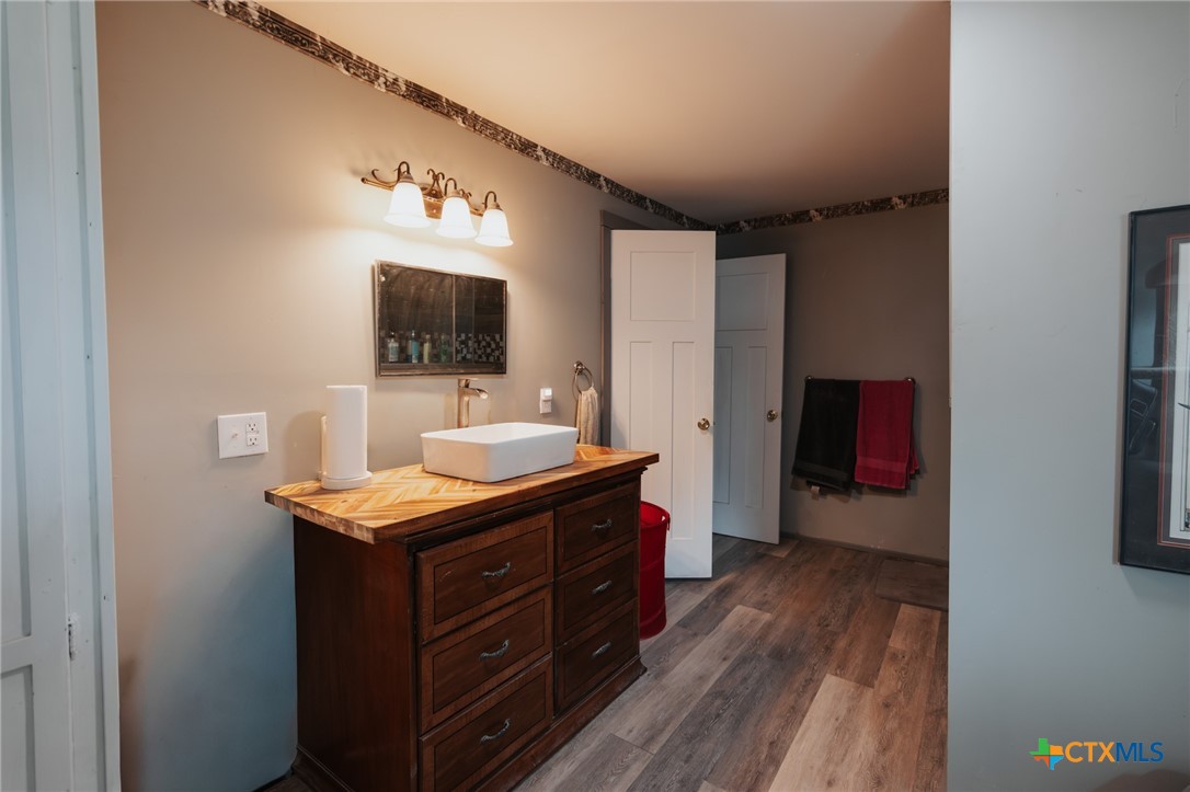 200 Williams Street Cuero, TX 77954 - Photo 12 of 17 a bathroom with a sink and a mirror