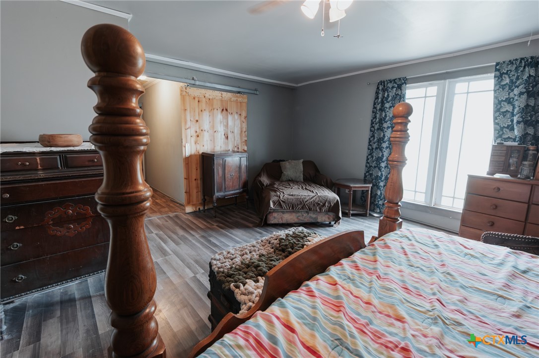 200 Williams Street Cuero, TX 77954 - Photo 14 of 17 a bedroom with a bed and wooden floor