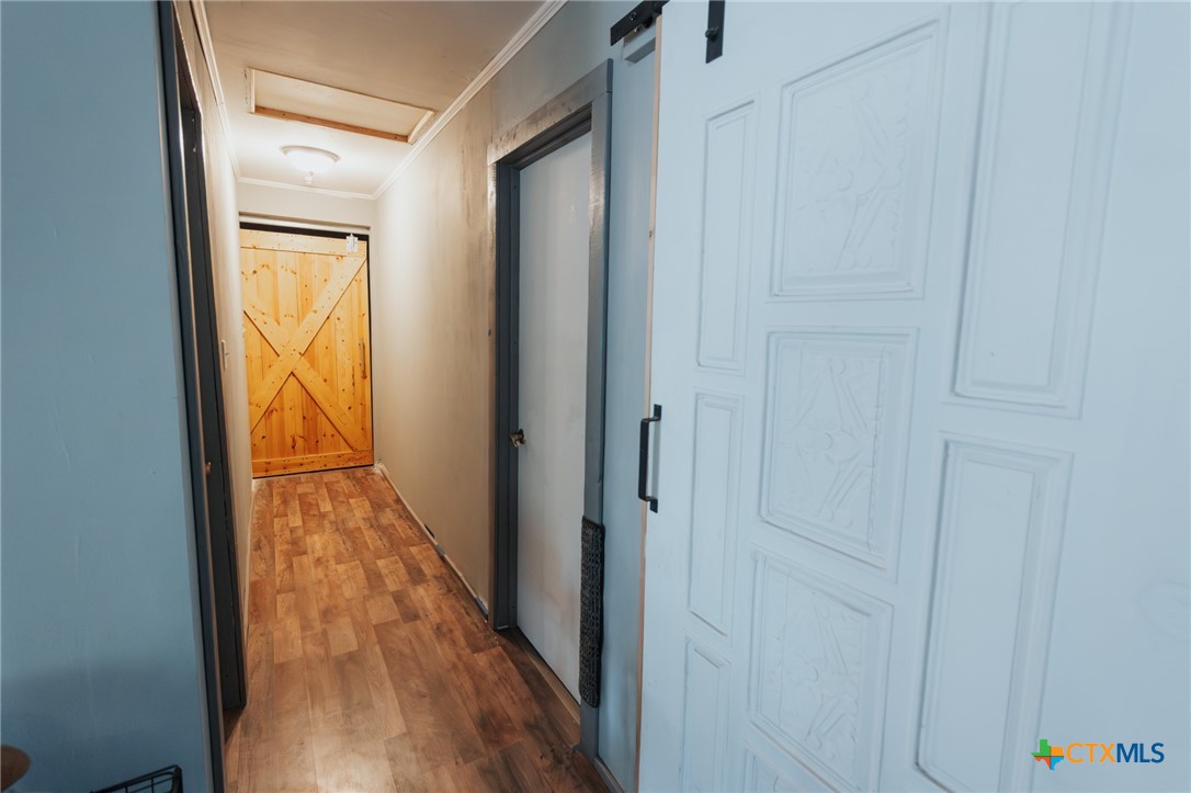 200 Williams Street Cuero, TX 77954 - Photo 9 of 17 a view of a hallway with wooden floor