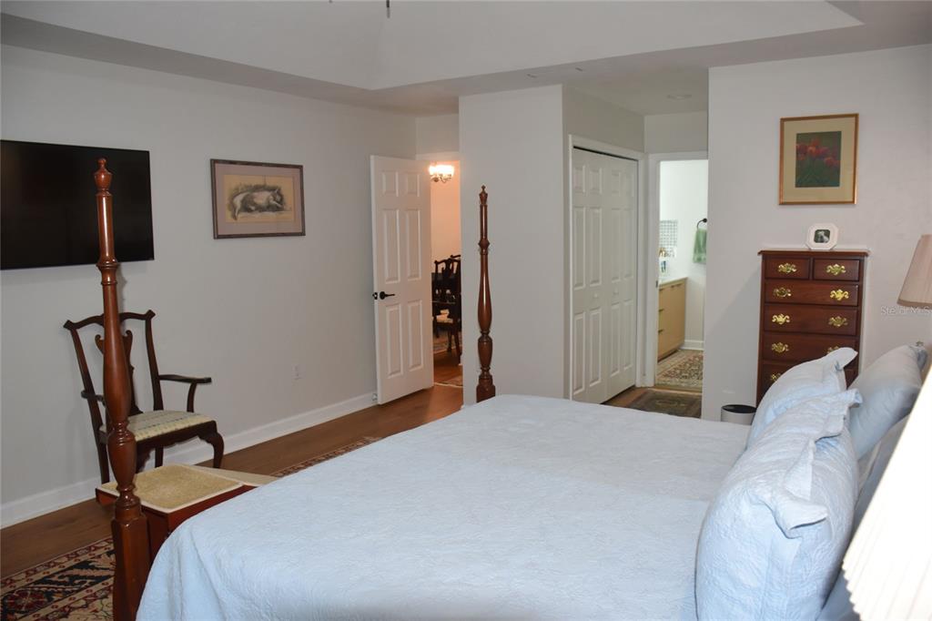2031 Southwest 75th Terrace Gainesville, FL 32607 - Photo 18 of 45 a bedroom with a bed and a flat tv screen on the dresser