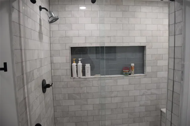 a bedroom with a bed and painting on the wall