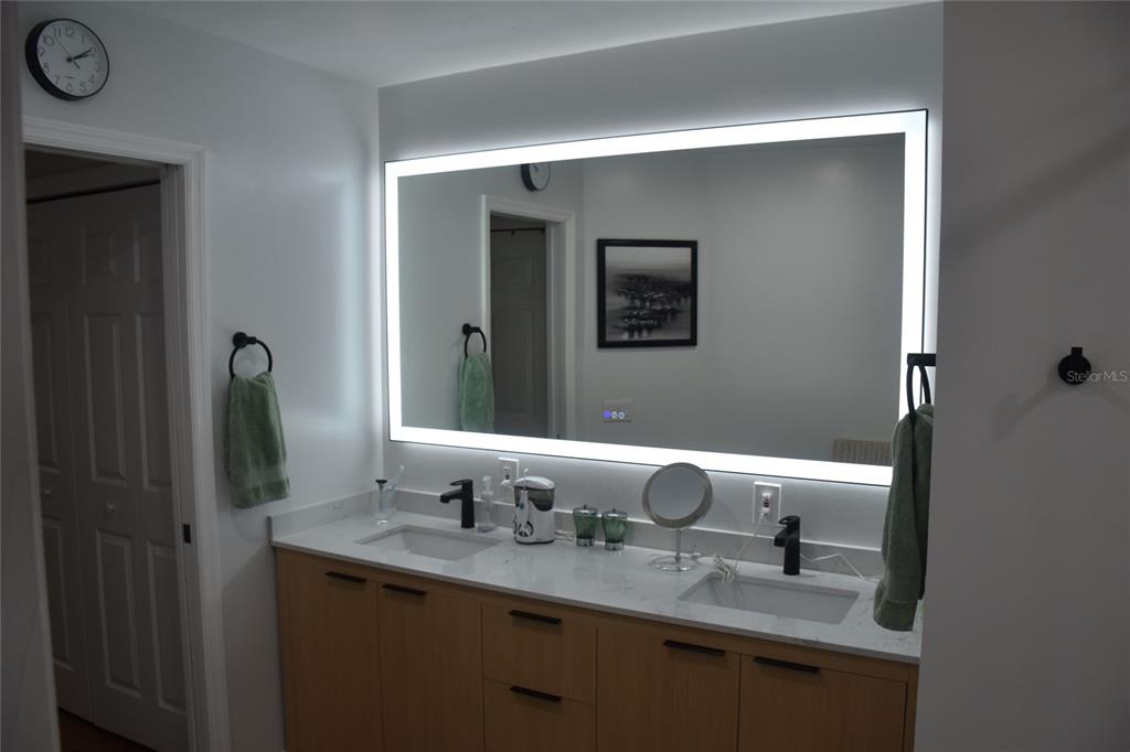 2031 Southwest 75th Terrace Gainesville, FL 32607 - Photo 27 of 45 a bathroom with a granite countertop sink and a mirror