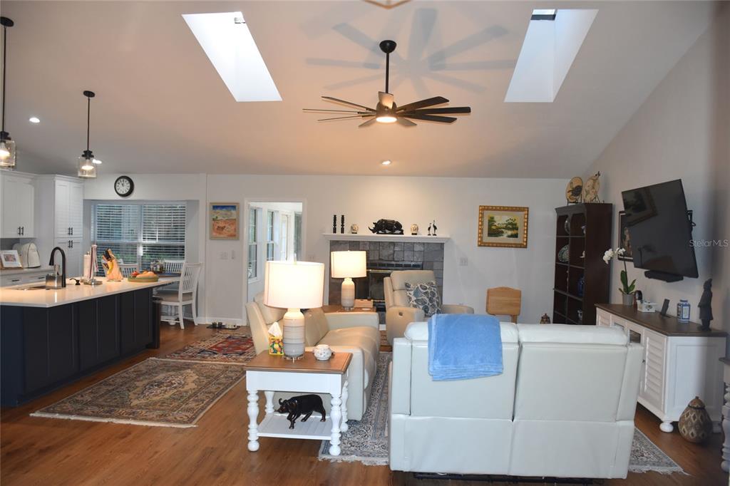 2031 Southwest 75th Terrace Gainesville, FL 32607 - Photo 3 of 45 a living room with furniture a flat screen tv and kitchen view