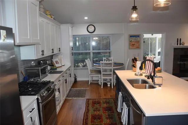 a view of a livingroom with furniture dining room and wooden floor