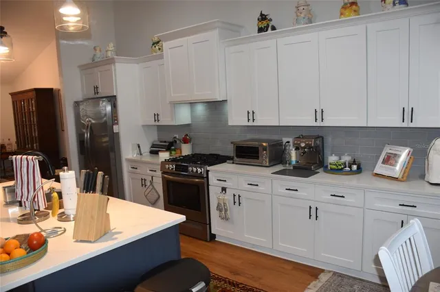 a view of kitchen with furniture and wooden floor
