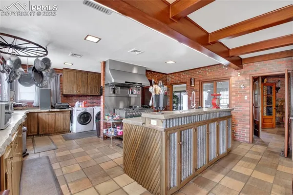 a kitchen with stainless steel appliances granite countertop a sink and cabinets