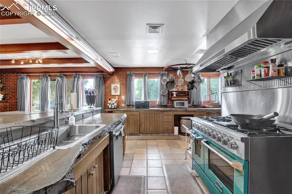 a kitchen with stainless steel appliances granite countertop a stove and a sink