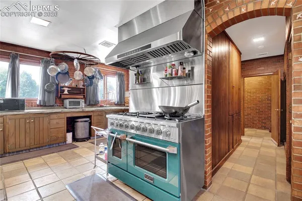 a kitchen with stainless steel appliances granite countertop a stove and a sink