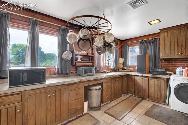 a kitchen with a sink cabinets and window
