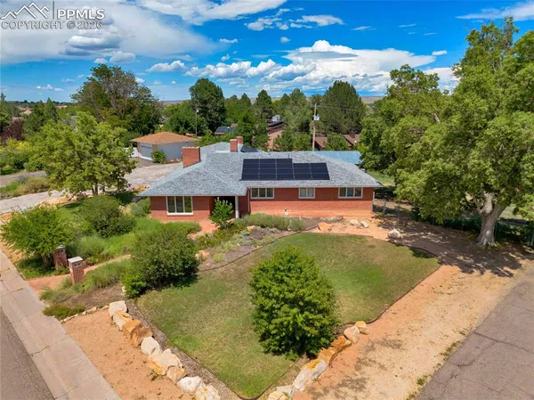 an aerial view of a house with a yard basket ball court and outdoor seating