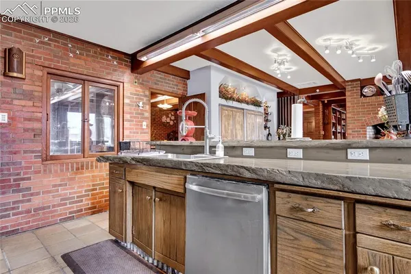 a bathroom with a granite countertop sink and a large mirror