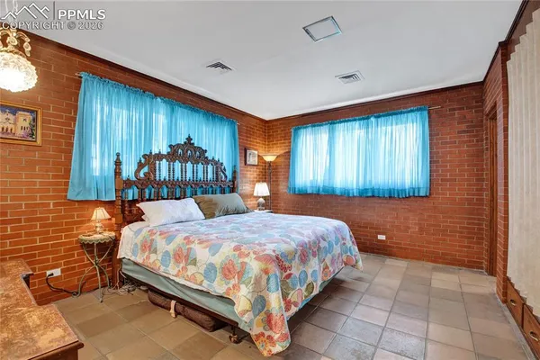 a bedroom with a large bed and a chandelier