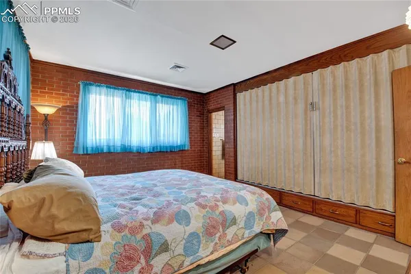 a bedroom with a large bed and a window