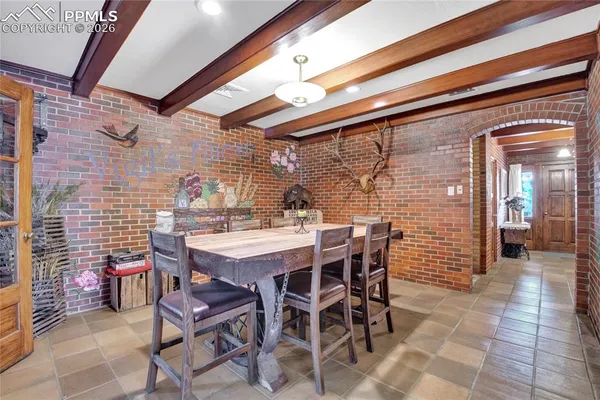 a view of a dining table and chairs in the patio