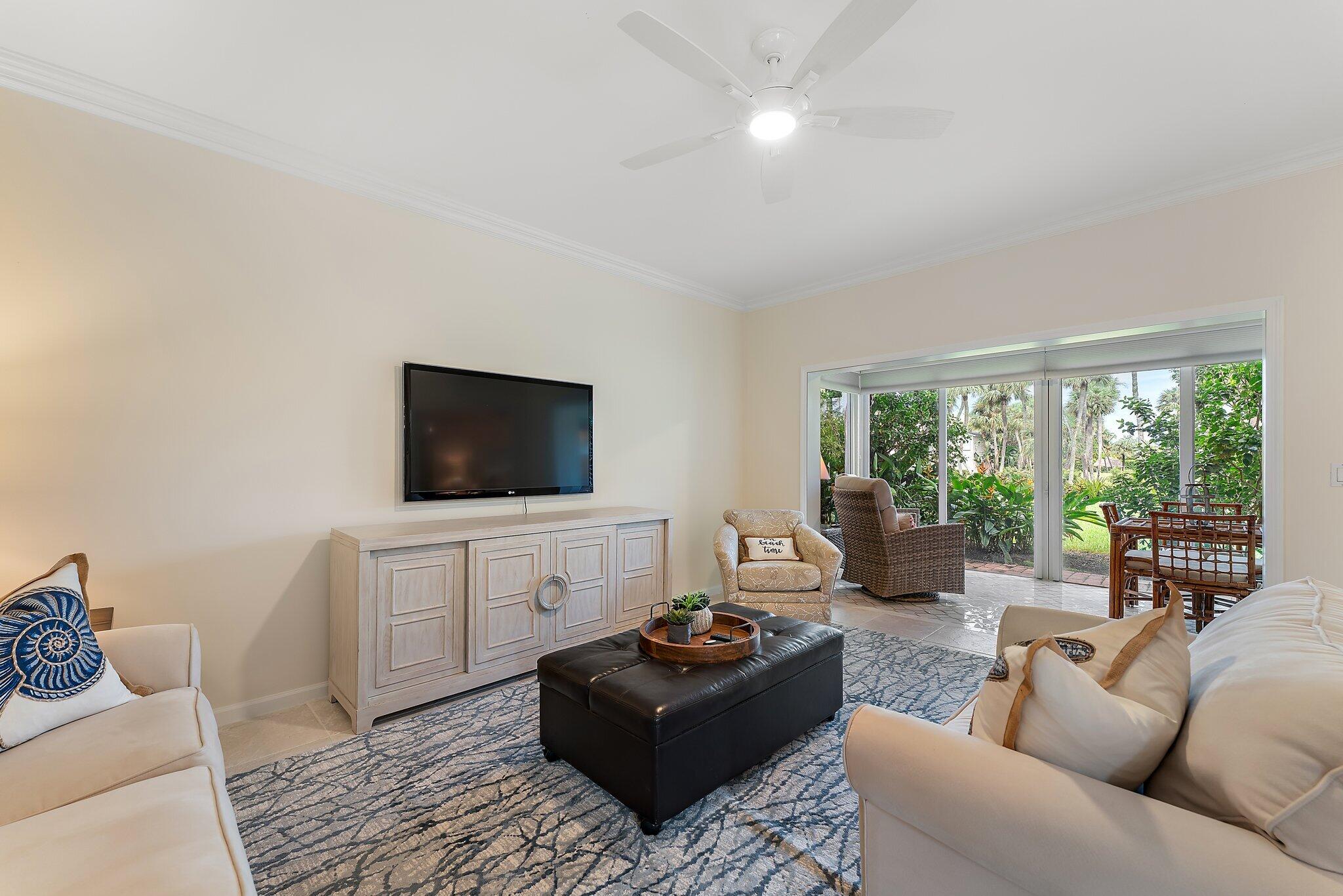 2905 Fairway Drive North Jupiter, FL 33477 - Photo 17 of 65 a living room with furniture and a flat screen tv