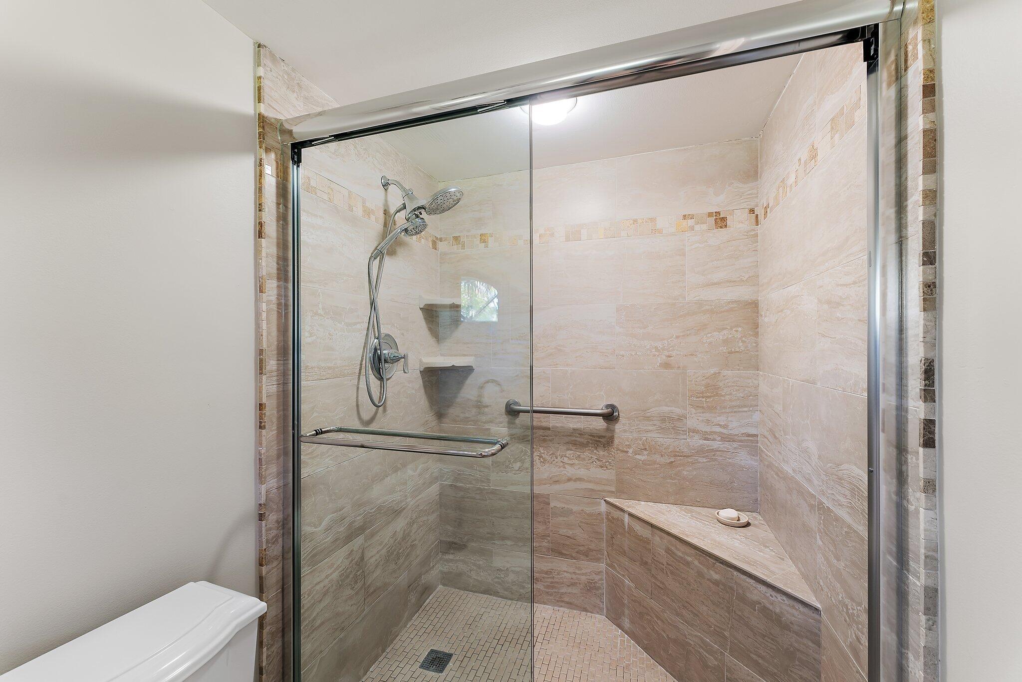 2905 Fairway Drive North Jupiter, FL 33477 - Photo 30 of 65 a bathroom with a glass shower door