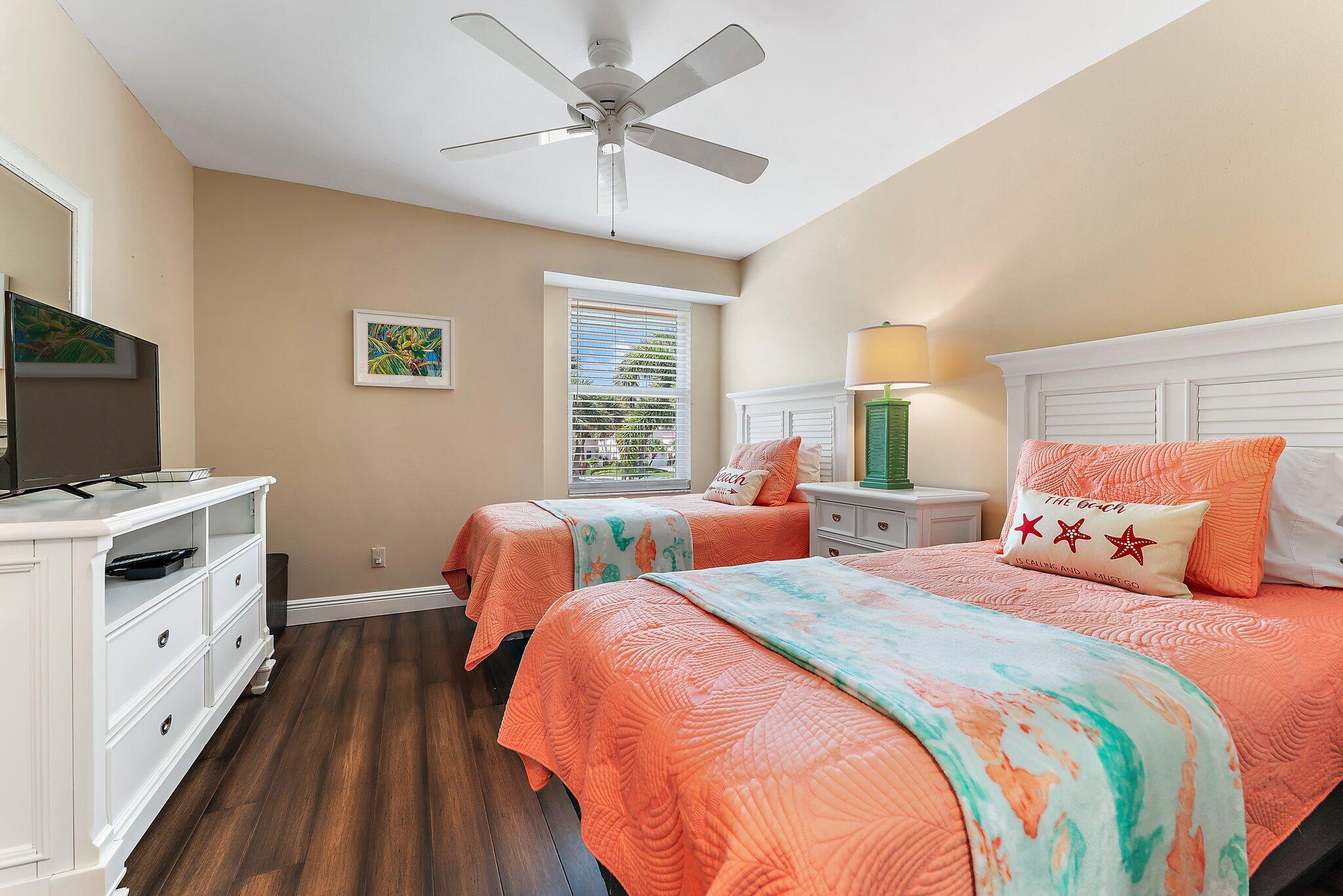 2905 Fairway Drive North Jupiter, FL 33477 - Photo 34 of 65 a bedroom with two beds and a chandelier