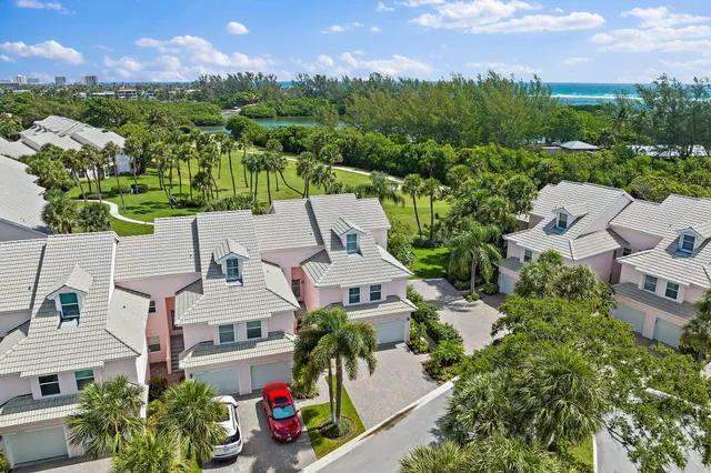 an aerial view of residential houses with outdoor space and street view