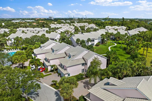 an aerial view of residential houses with outdoor space and river