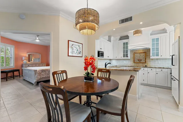 a kitchen with granite countertop white cabinets and sink