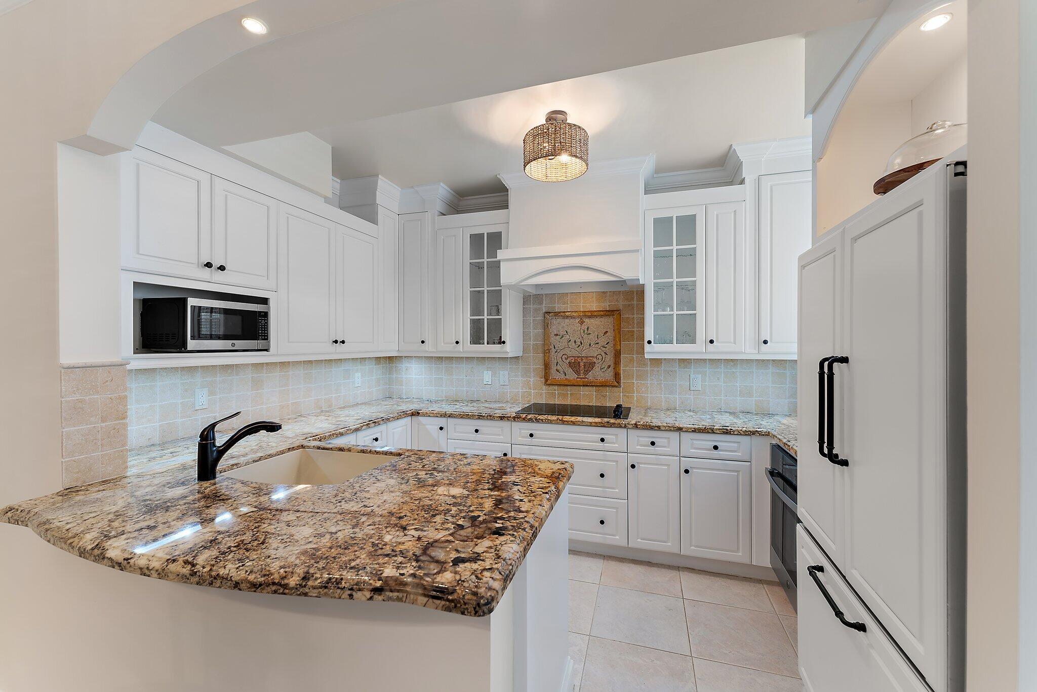 2905 Fairway Drive North Jupiter, FL 33477 - Photo 8 of 65 a kitchen with stainless steel appliances granite countertop a sink a stove and a refrigerator