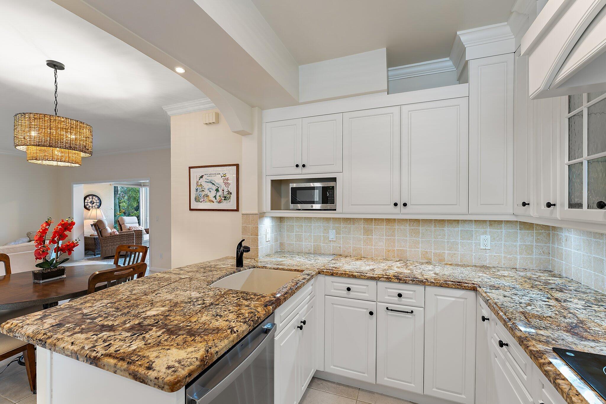 2905 Fairway Drive North Jupiter, FL 33477 - Photo 10 of 65 a kitchen with stainless steel appliances granite countertop a sink stove and white cabinets