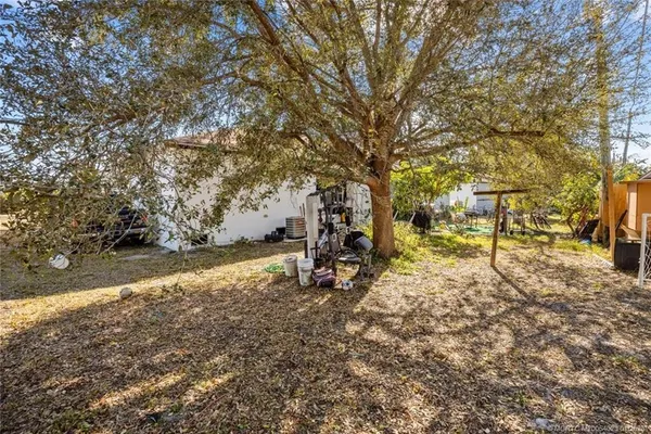 a view of a yard with large trees