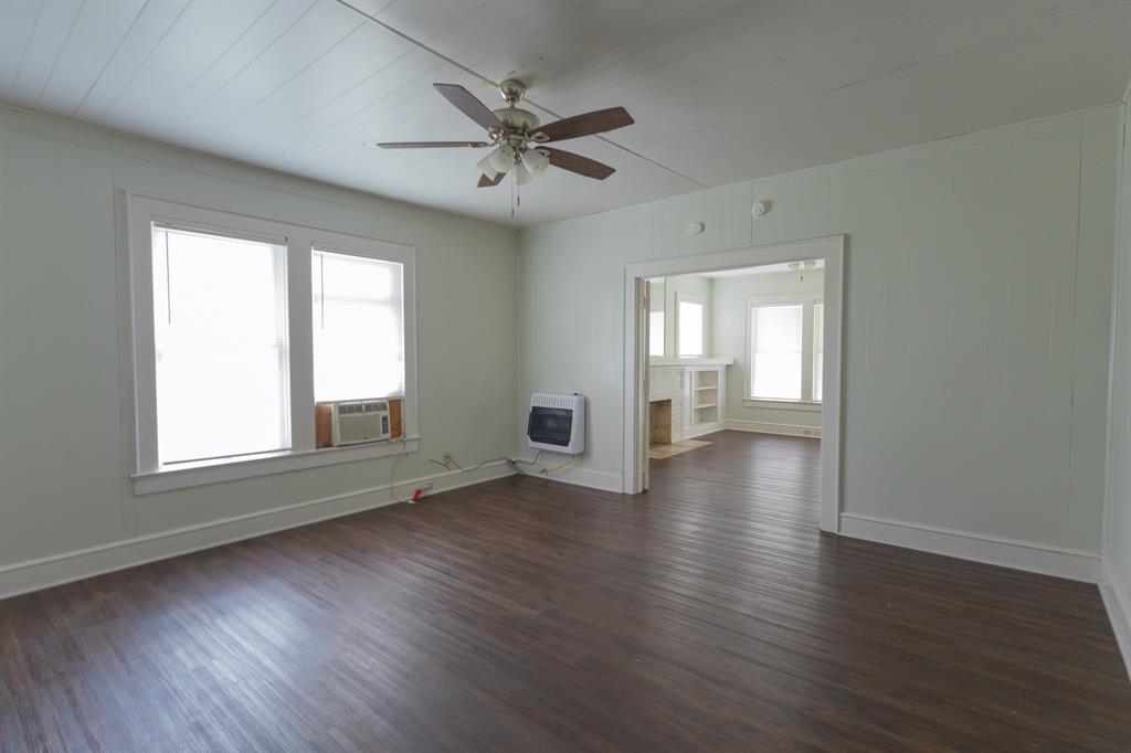 2913 Homan Avenue, Unit 2913 Waco, TX 76707 - Photo 7 of 16 Spacious room featuring wood-finish flooring, white paneled walls, and a ceiling fan