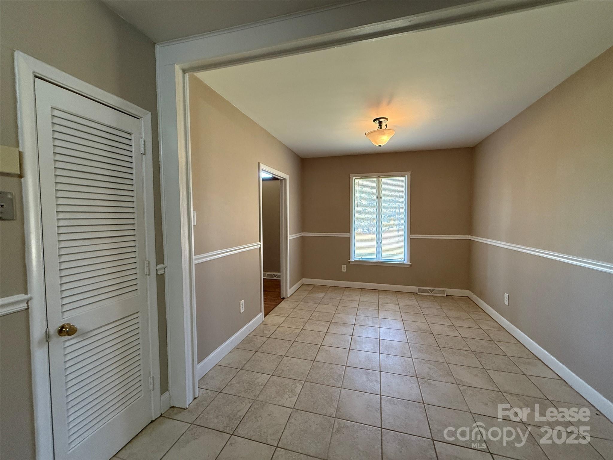 925 Perth Road Troutman, NC 28166 - Photo 12 of 31 a view of an empty room with window and cabinet