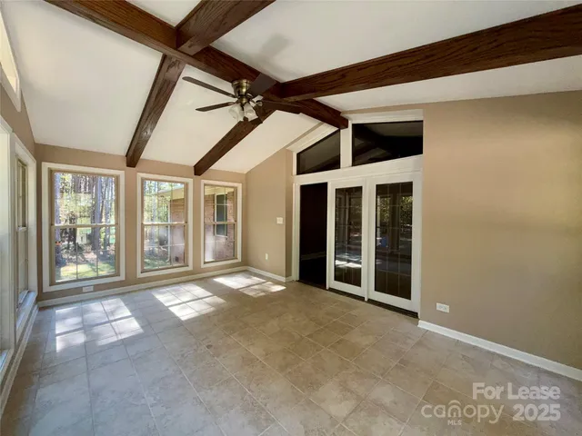 a view of an empty room with windows